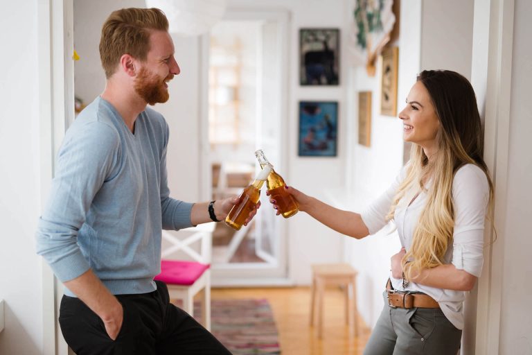 happy-couple-drinking-beer-and-toasting-at-home-UWT3974-1-1.jpg